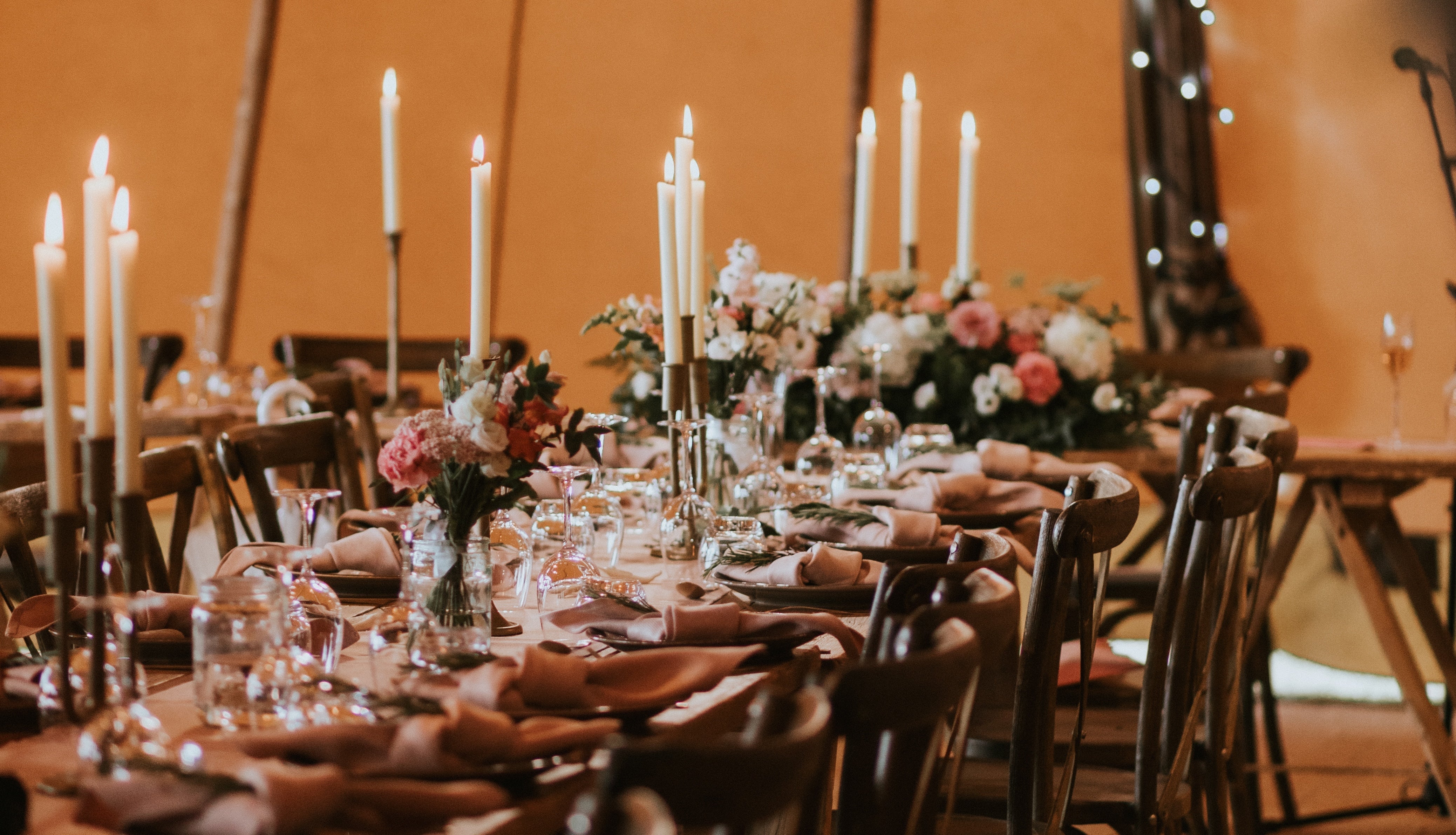 wedding table setting with country flowers and romantic candlelight