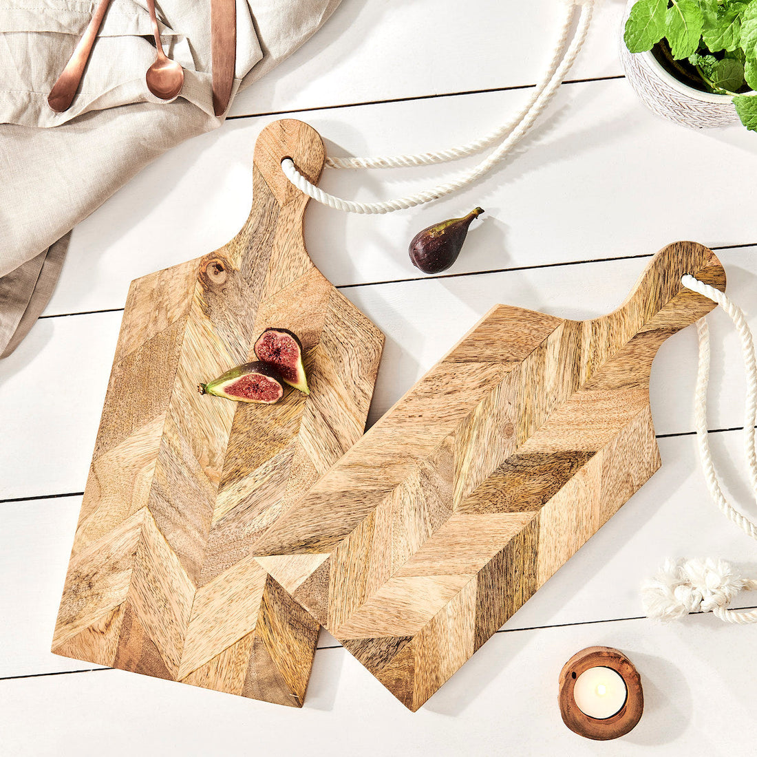 mango wood chopping boards on kitchen table with figs and herbs