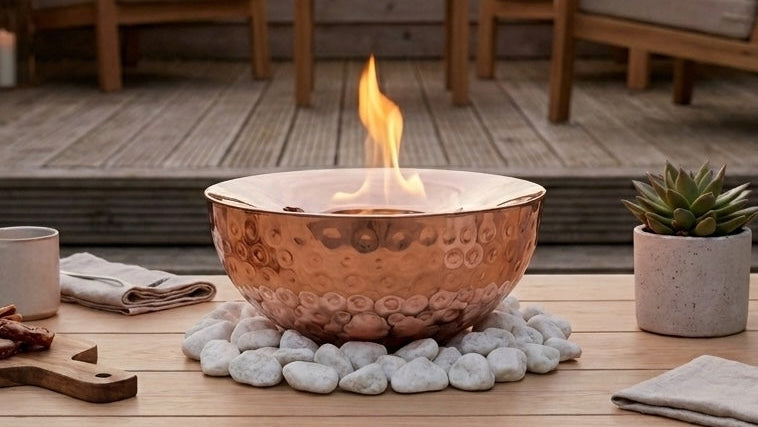 garden fire bowl on garden table with seating behind on a patio