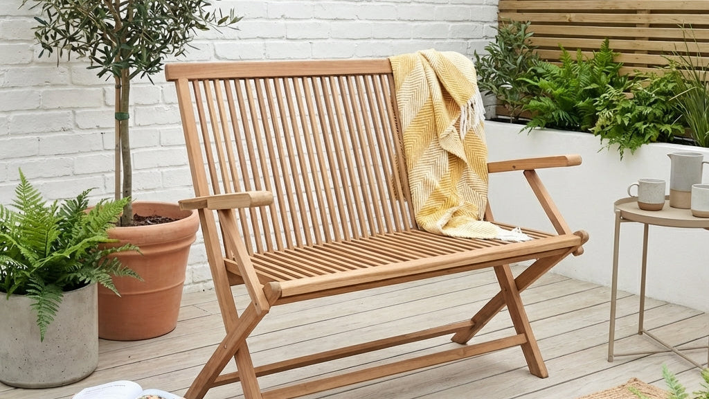 garden decking with wooden folding bench and plants in pots