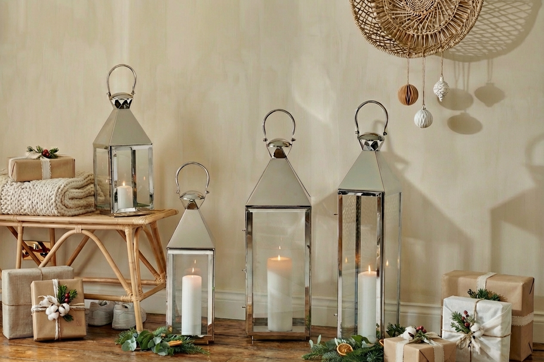 tall silver floor lanterns grouped together on the floor with christmas presents and blanket