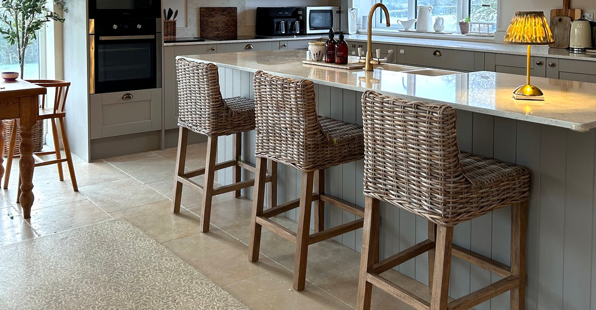 farmhouse kitchen with wicker bar stools at kitchen island