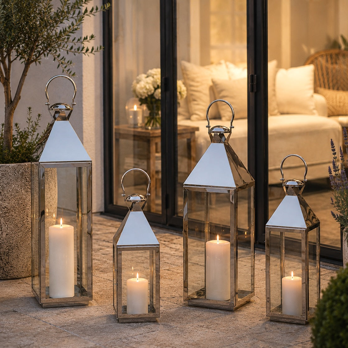floor silver candle lanterns on garden patio at dusk with glass patio doors behind