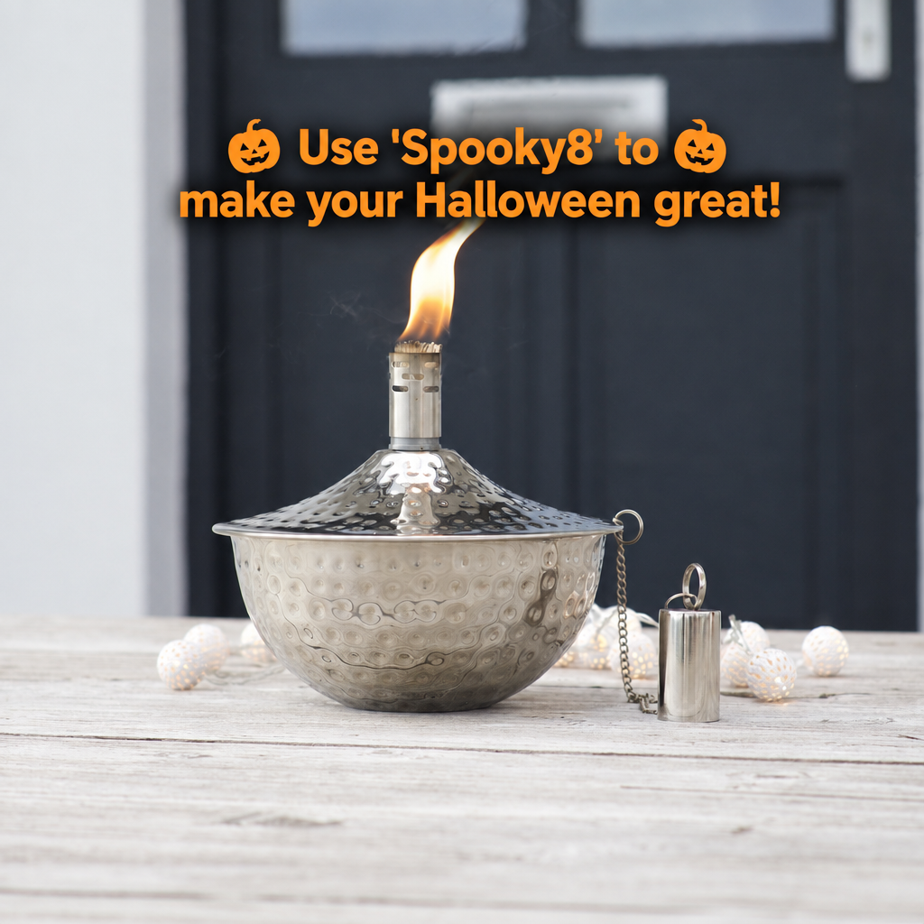 Silver hand hammered oil lamp on a table with flame lit and text giving the discount code Spooky8