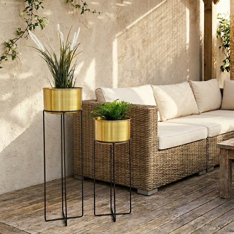 brass plant pots on garden patio with rattan sofa