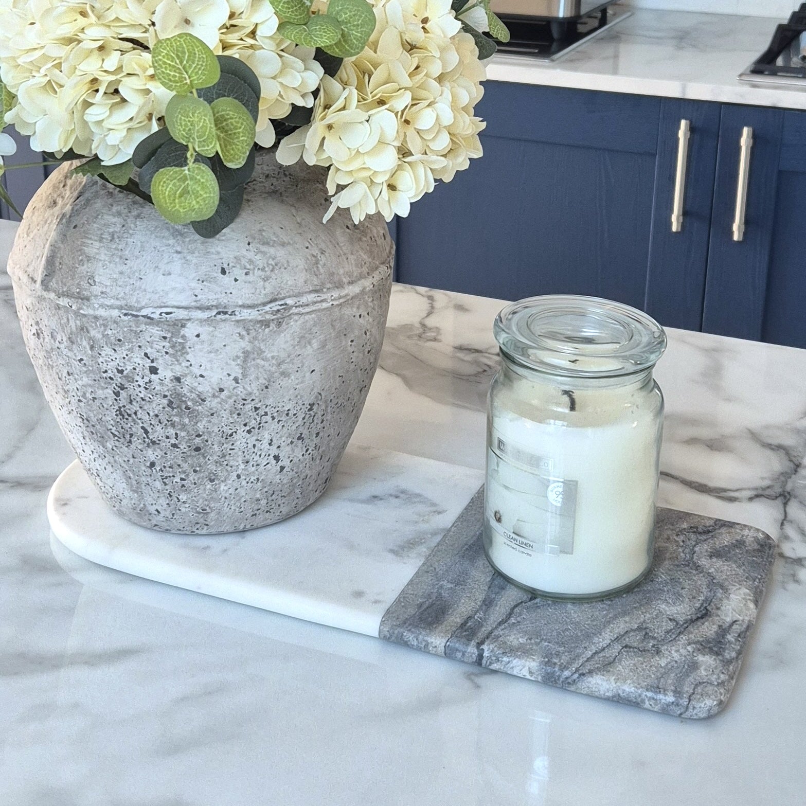 marble serving board on table with candle and flowers