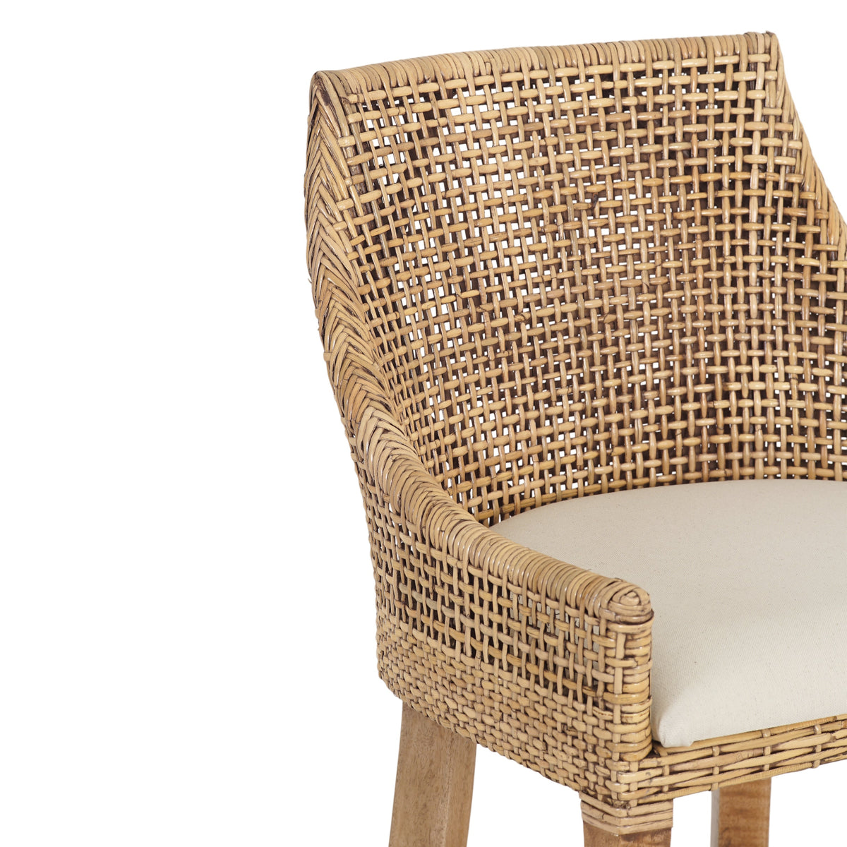 Close-up of a woven wicker or rattan chair with a curved back, armrests, light wood legs, and a cream-colored seat cushion on a white background.