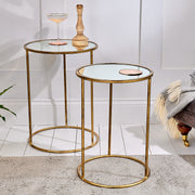 Mirrored nest of tables on white floor with rug