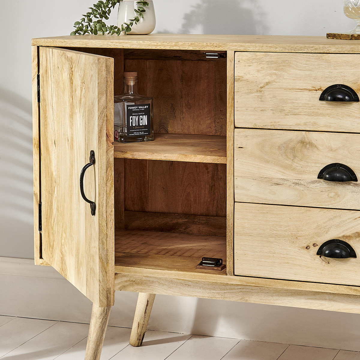 Natural wooden sideboard with open door