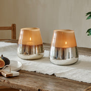 Tall indoor hurricane candle lamp metallic, on wooden table with cotton runner