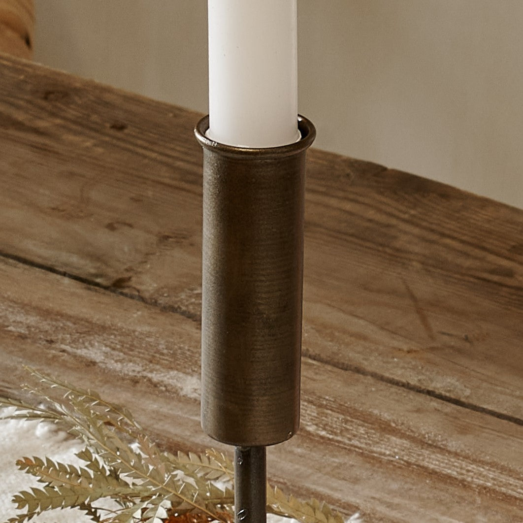 Close up of metal candlestick with white candle