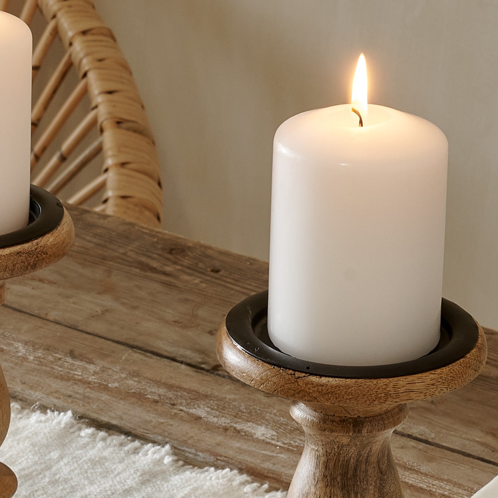 Top of dark wood candle stick with candle