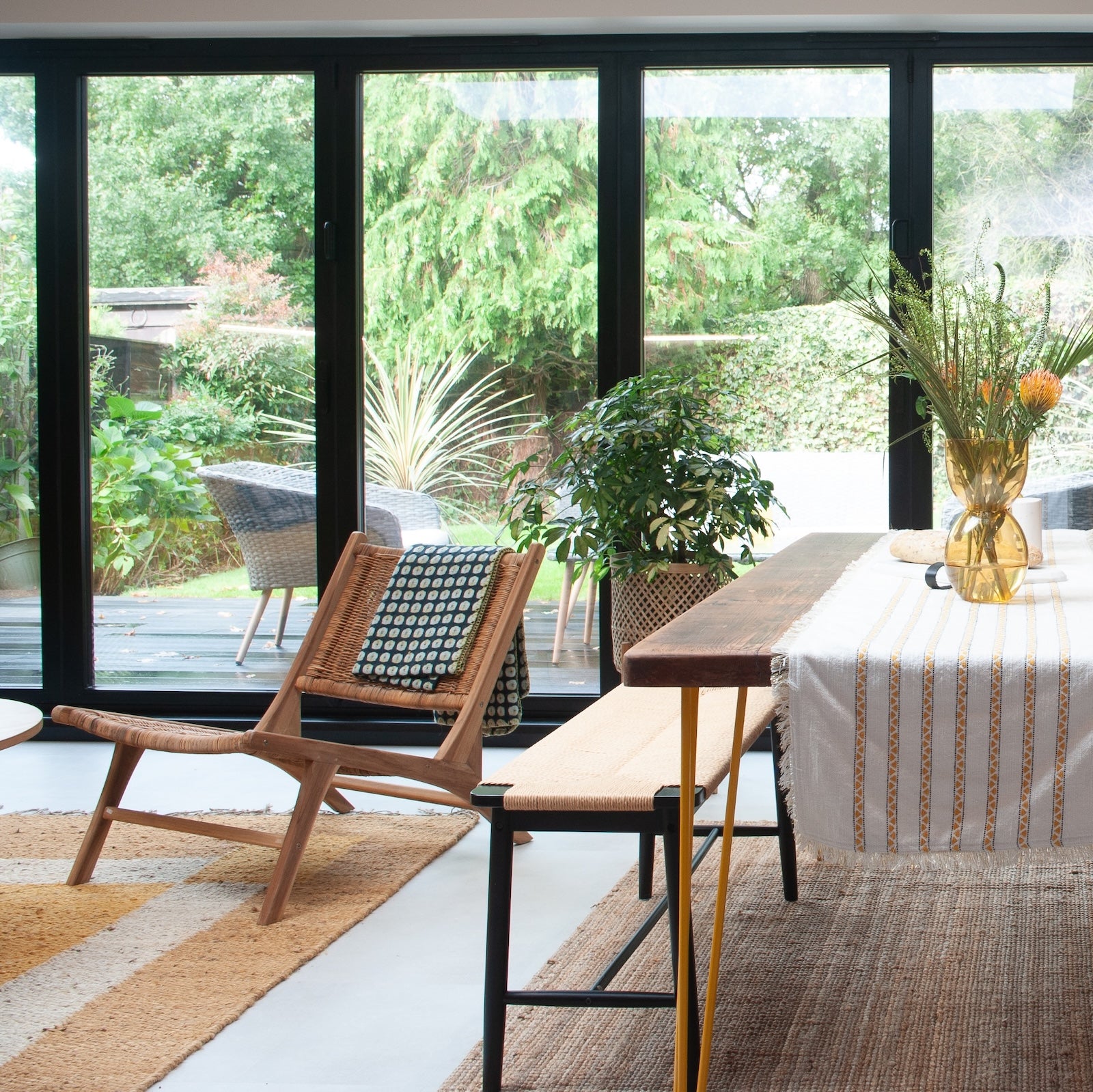 kitchen dining area with glass patio doors and rattan armchair