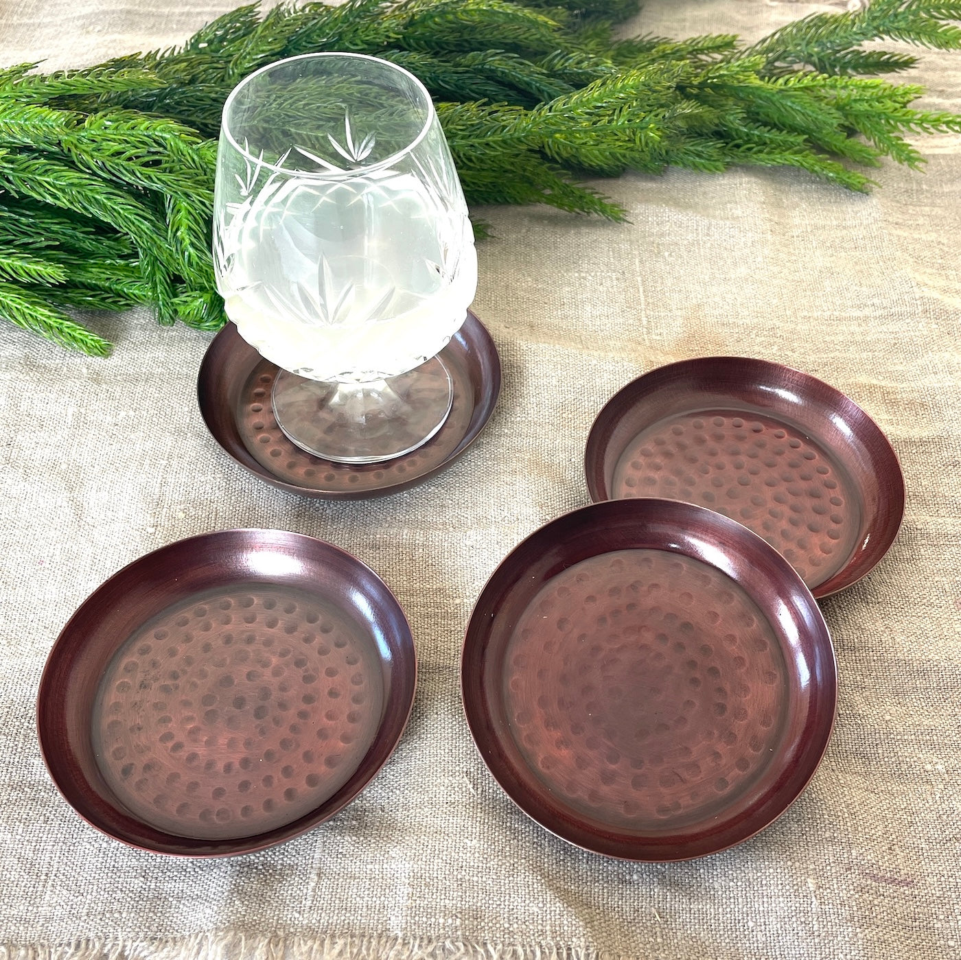 drink coasters copper on tablet setting with wine glass