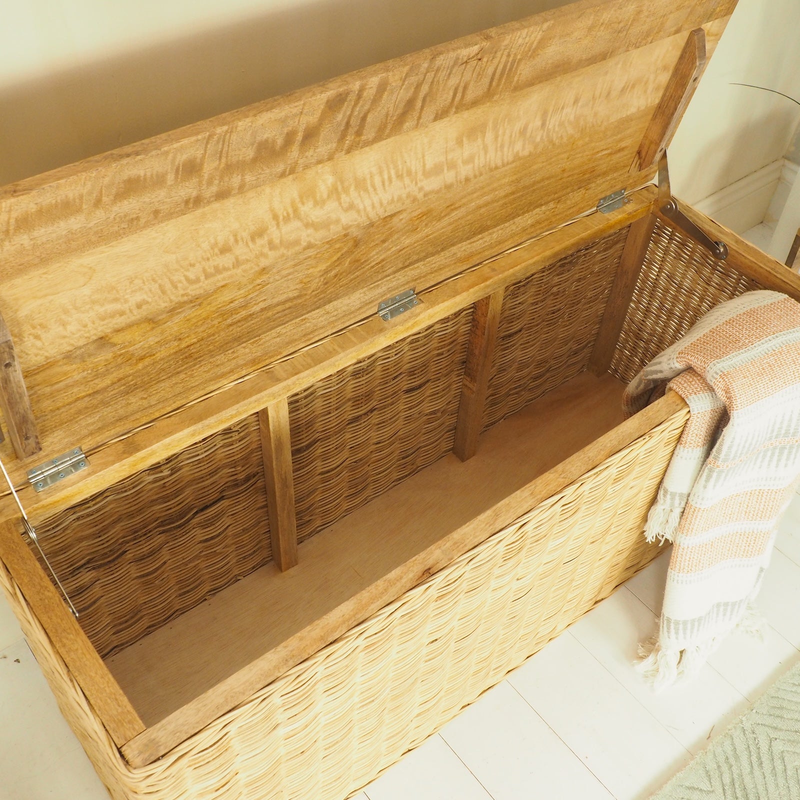 Wicker and wood hallway storage bench with lid open
