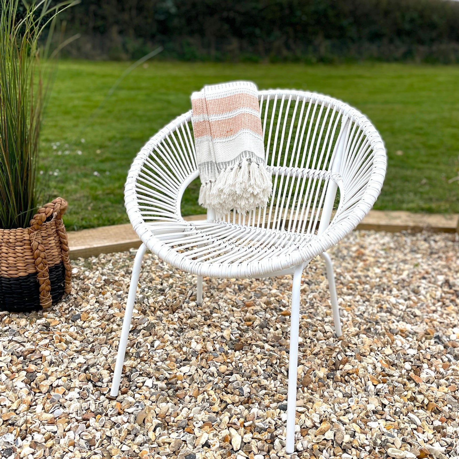 White garden chair bamboo on patio with grass