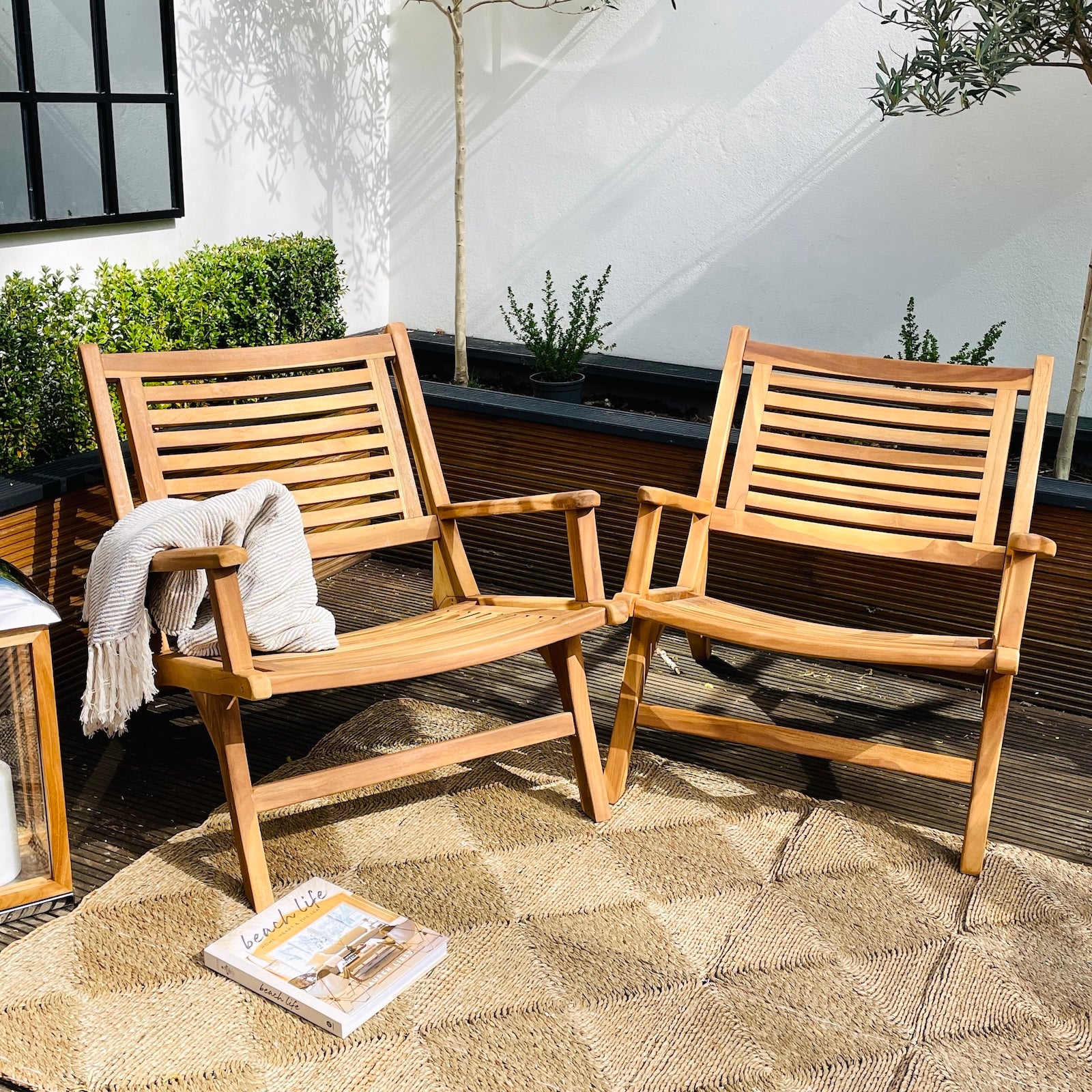 set of two garden chairs on patio with garden rug