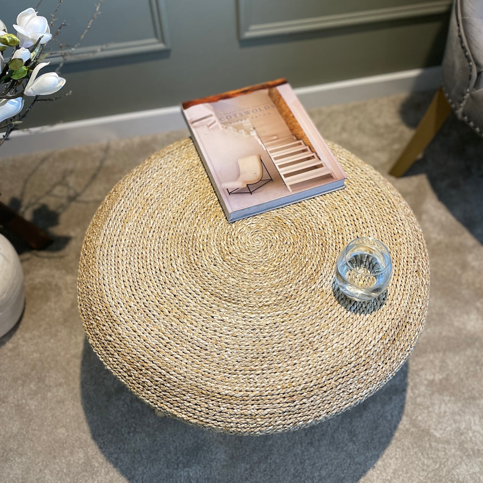 seagrass coffee table with book and water glass