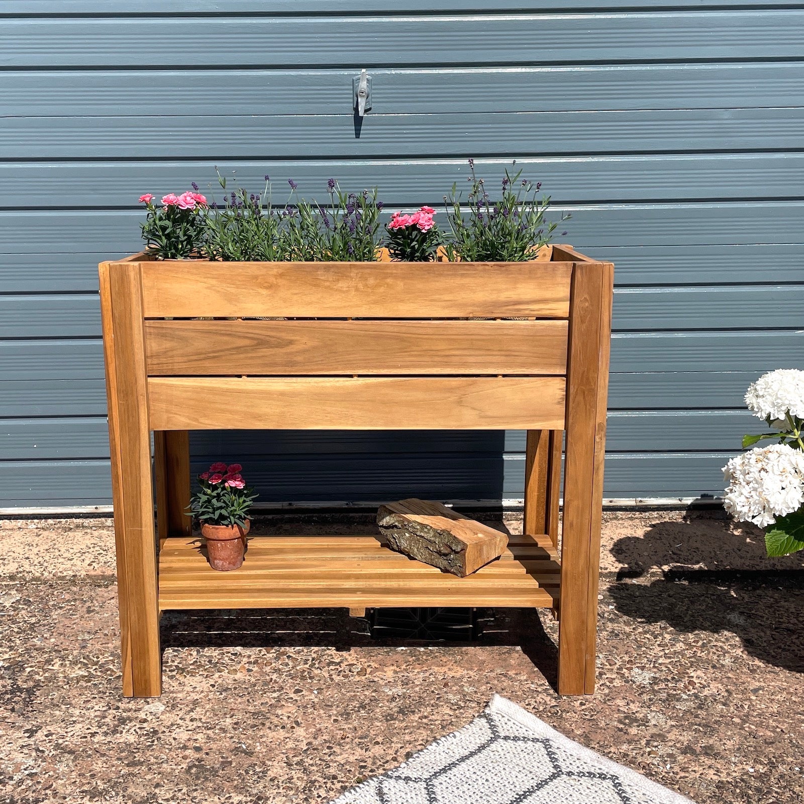 Wooden garden planter with flowers