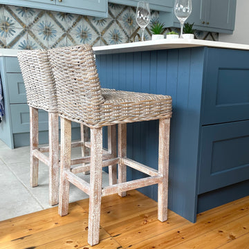 Whitewash wicker kitchen stool at kitchen island