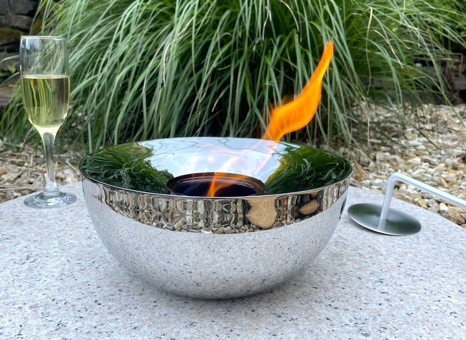 Garden silver gel burner outdoors with grass and glass