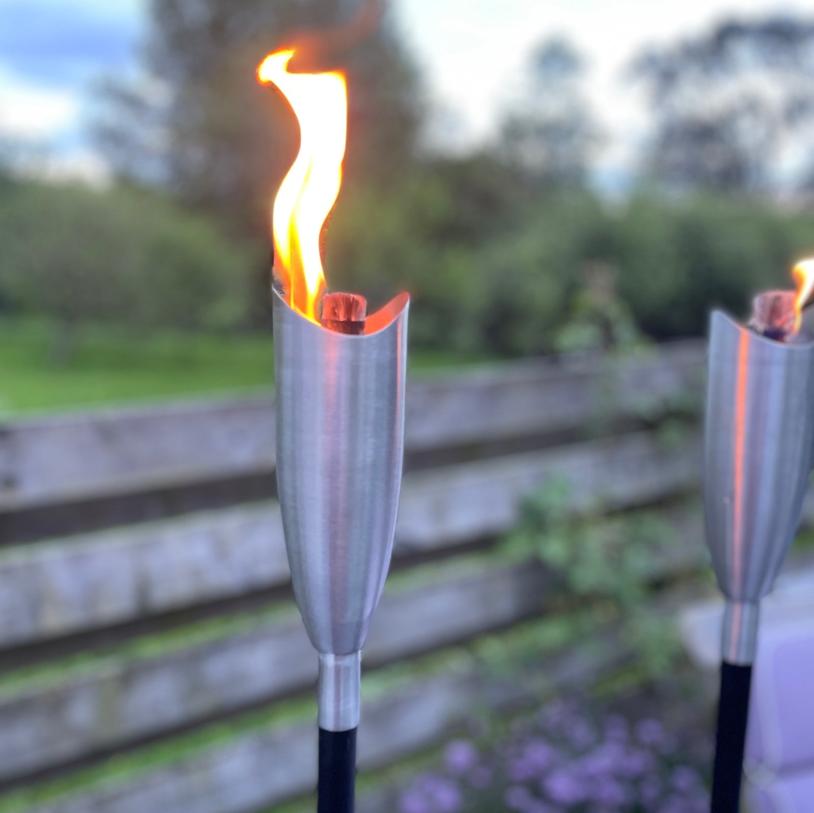 garden tiki torch on patio with flame