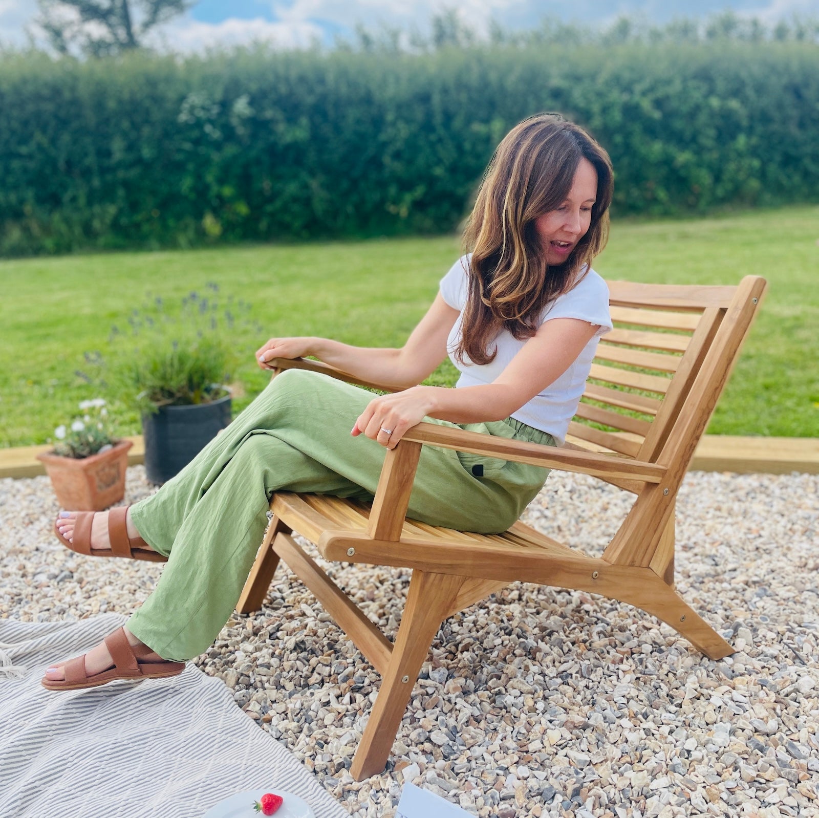 girl sat on garden arm chair wood