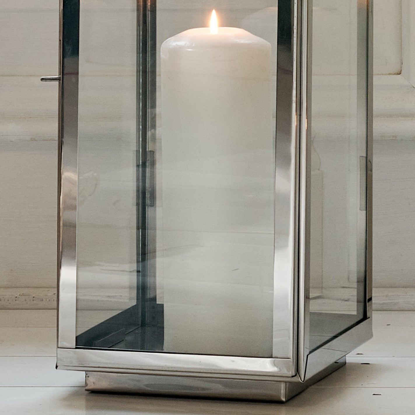 Close up of base of Mango wood and metal candle lantern with white pillar candle
