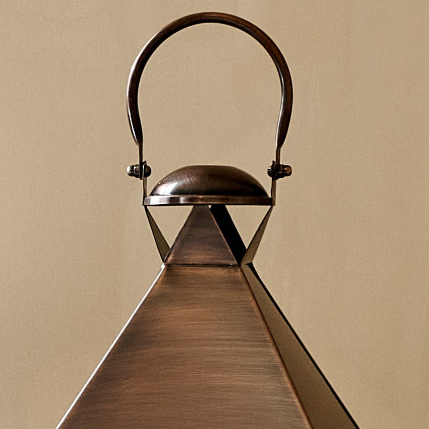 Close up of hood and handle of aged copper lantern
