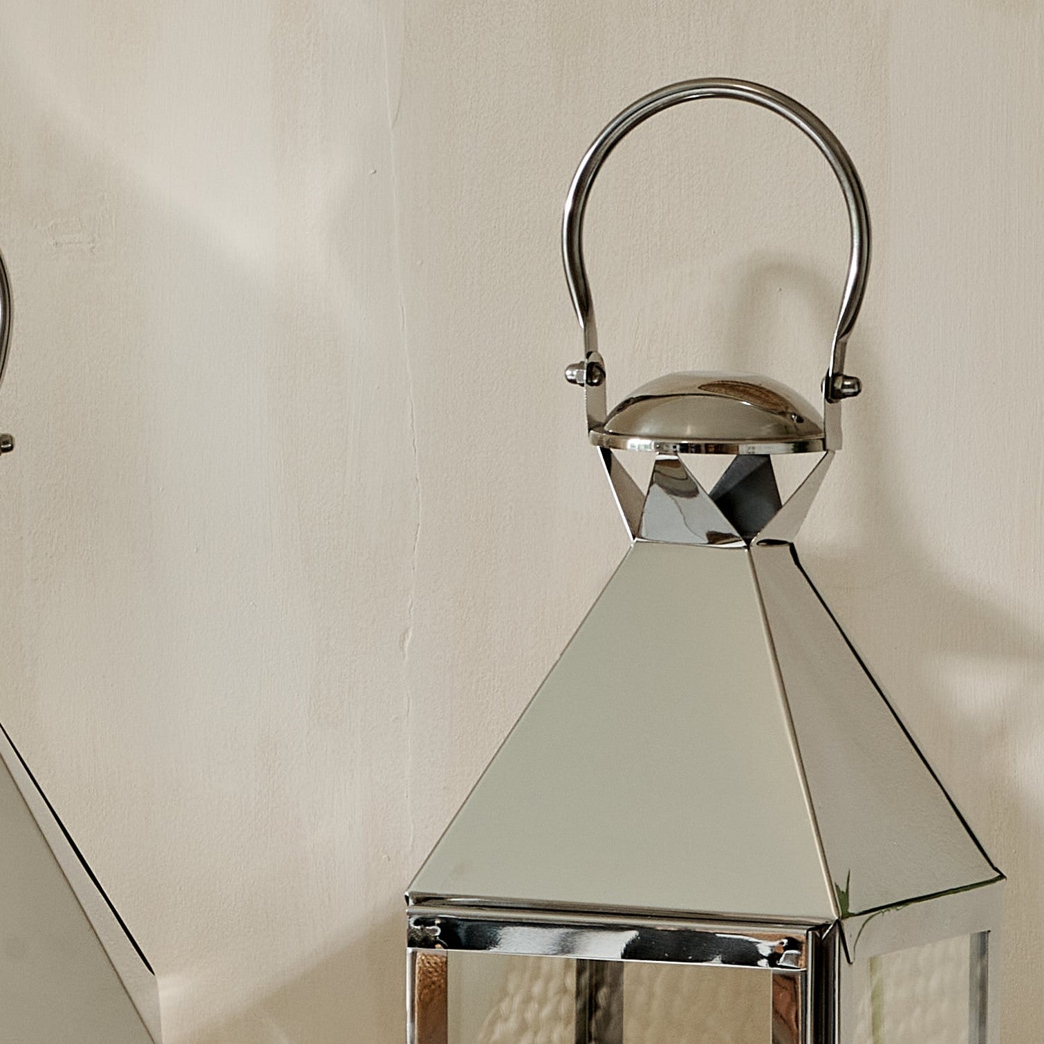 Close up of hood and handle of metal candle holder