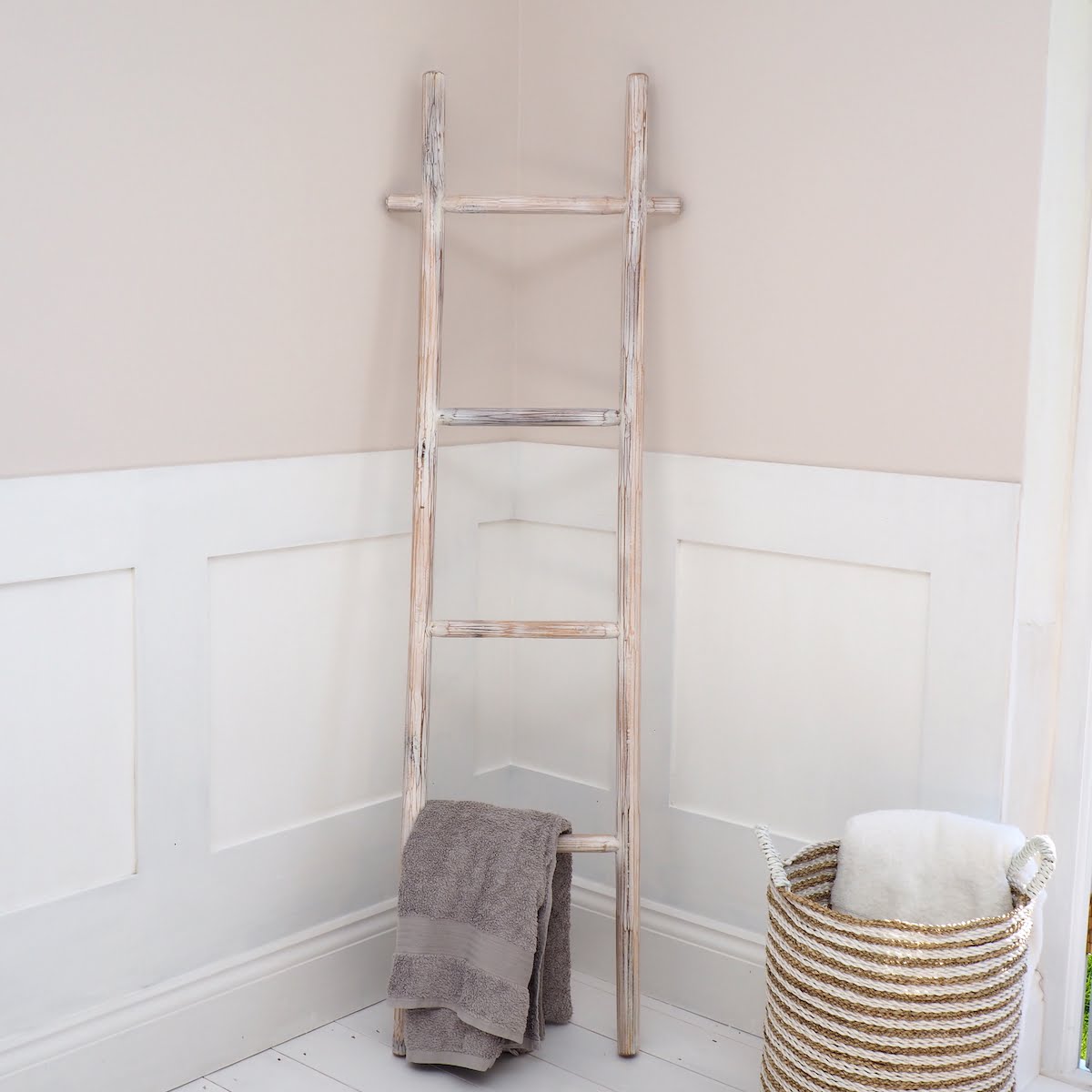 Striped Wicker Basket in Bathroom with wooden towel rack