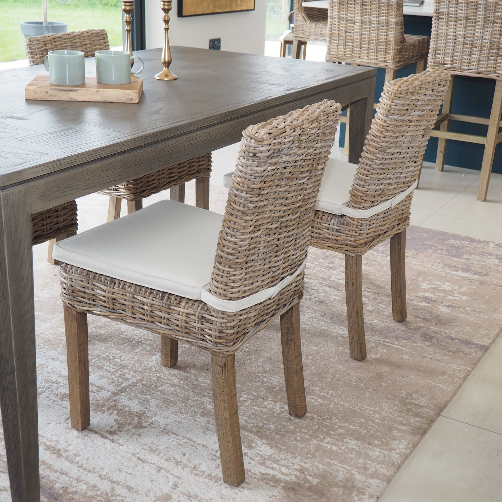 rattan dining chair with cream cushion, at dining table