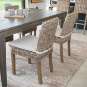rattan dining chair with cream cushion, at dining table