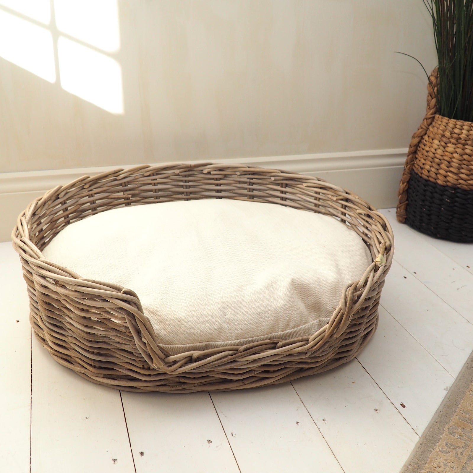 Round wicker dog bed in lounge