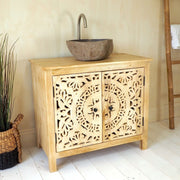 Natural carved vanity unit with stone sink on white wooden floor