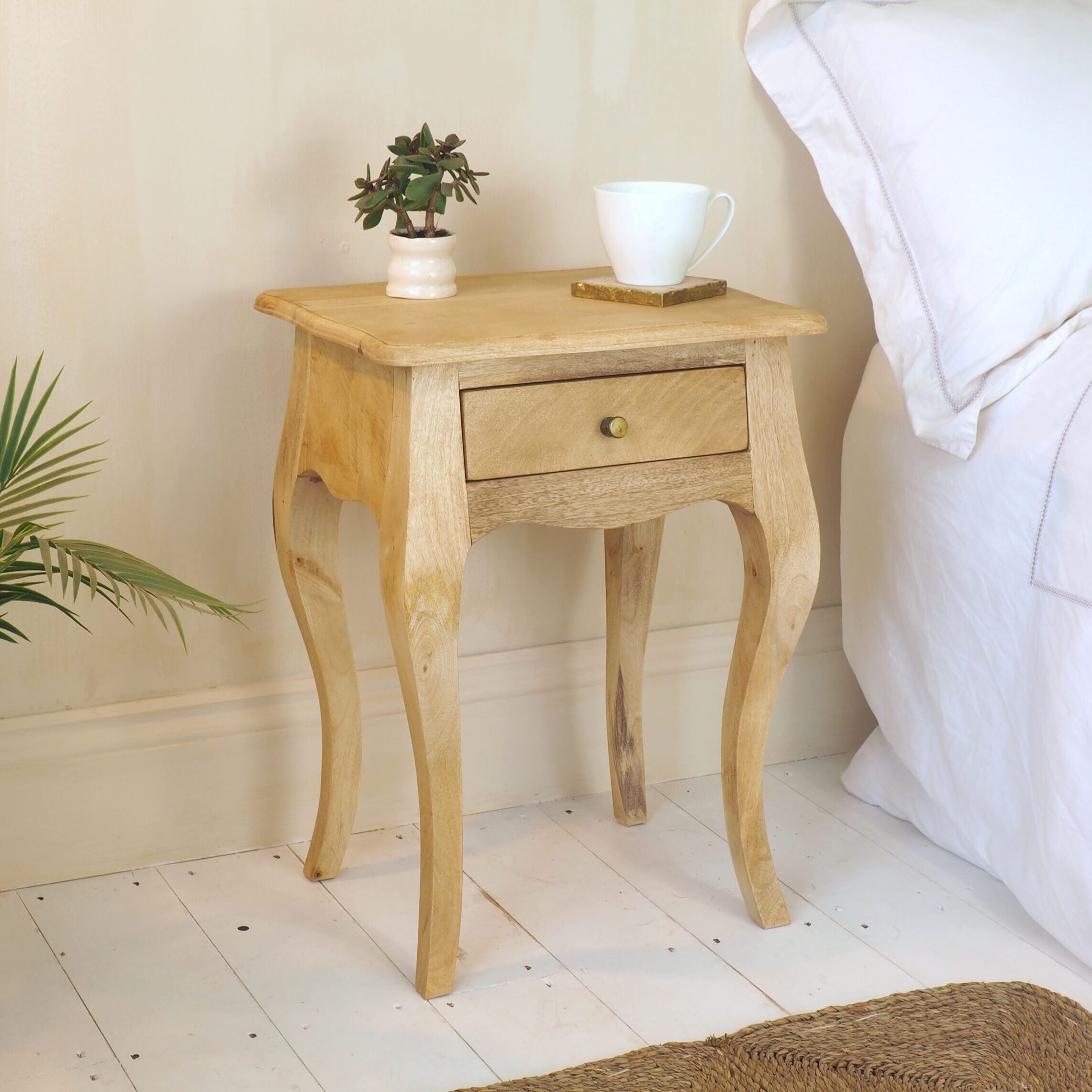 Natural Bedside Table on white wooden floor in bedroom setting