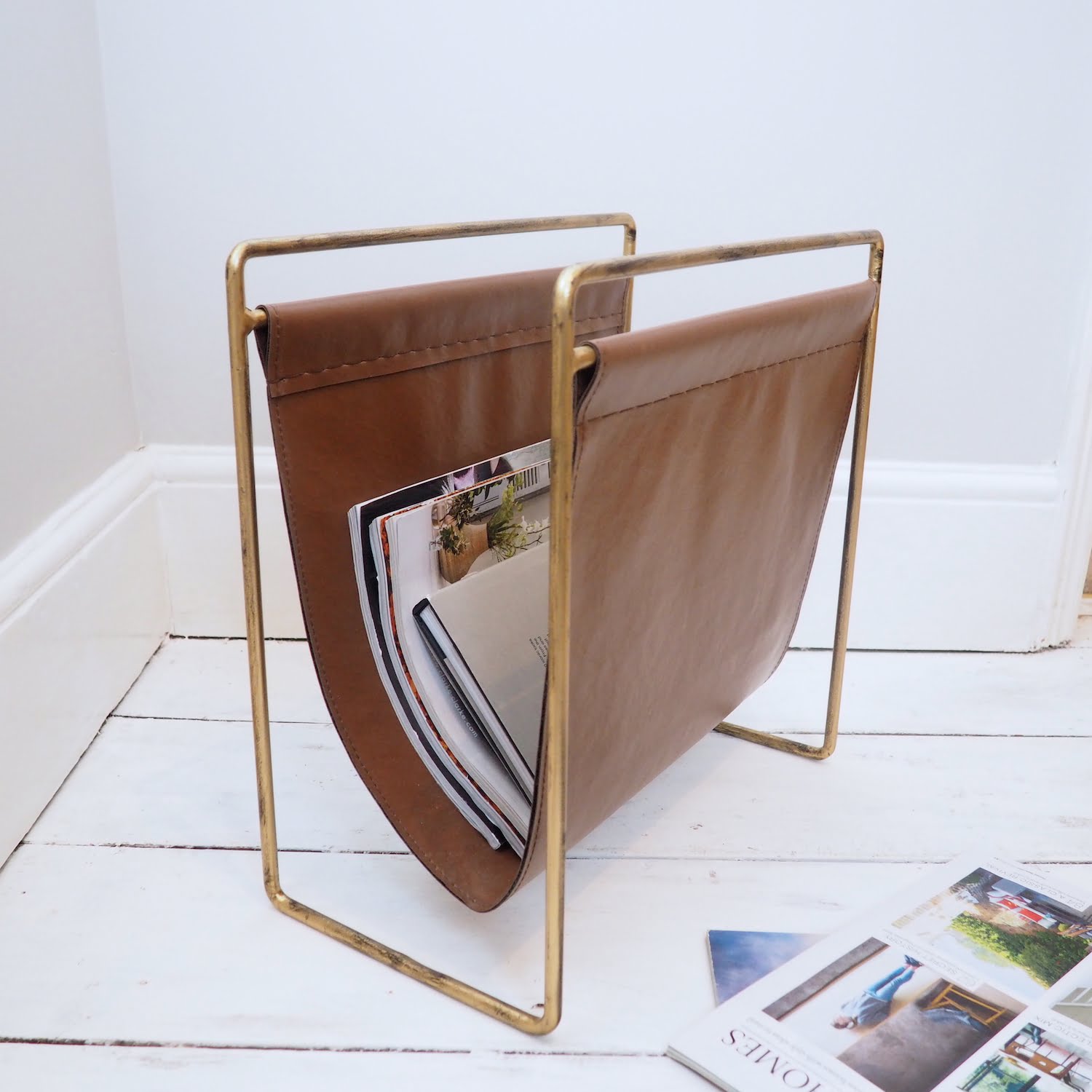 Living room leather magazine rack on white wooden floor