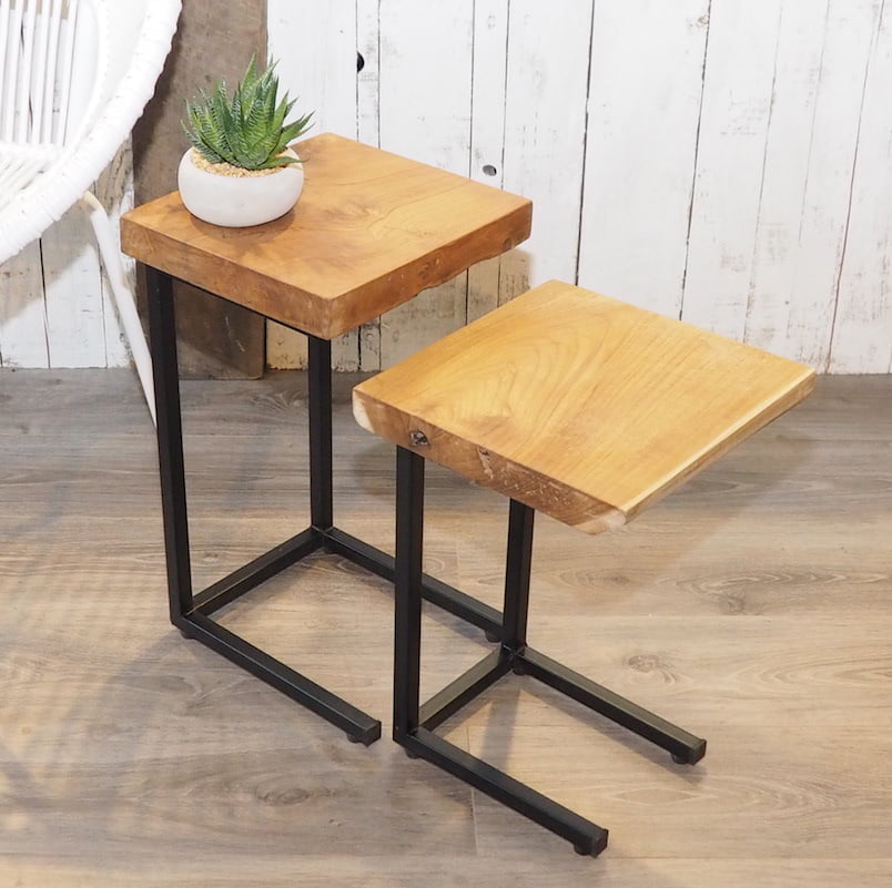 Nest of two tables separate on wooden floor in front of white wood wall