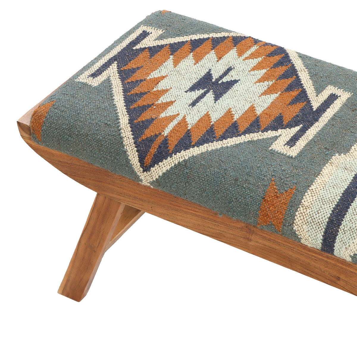 A patterned uphoulstered coloured wooden bench with a woven geometric patterned seat cushion in blue, orange, cream, and navy.