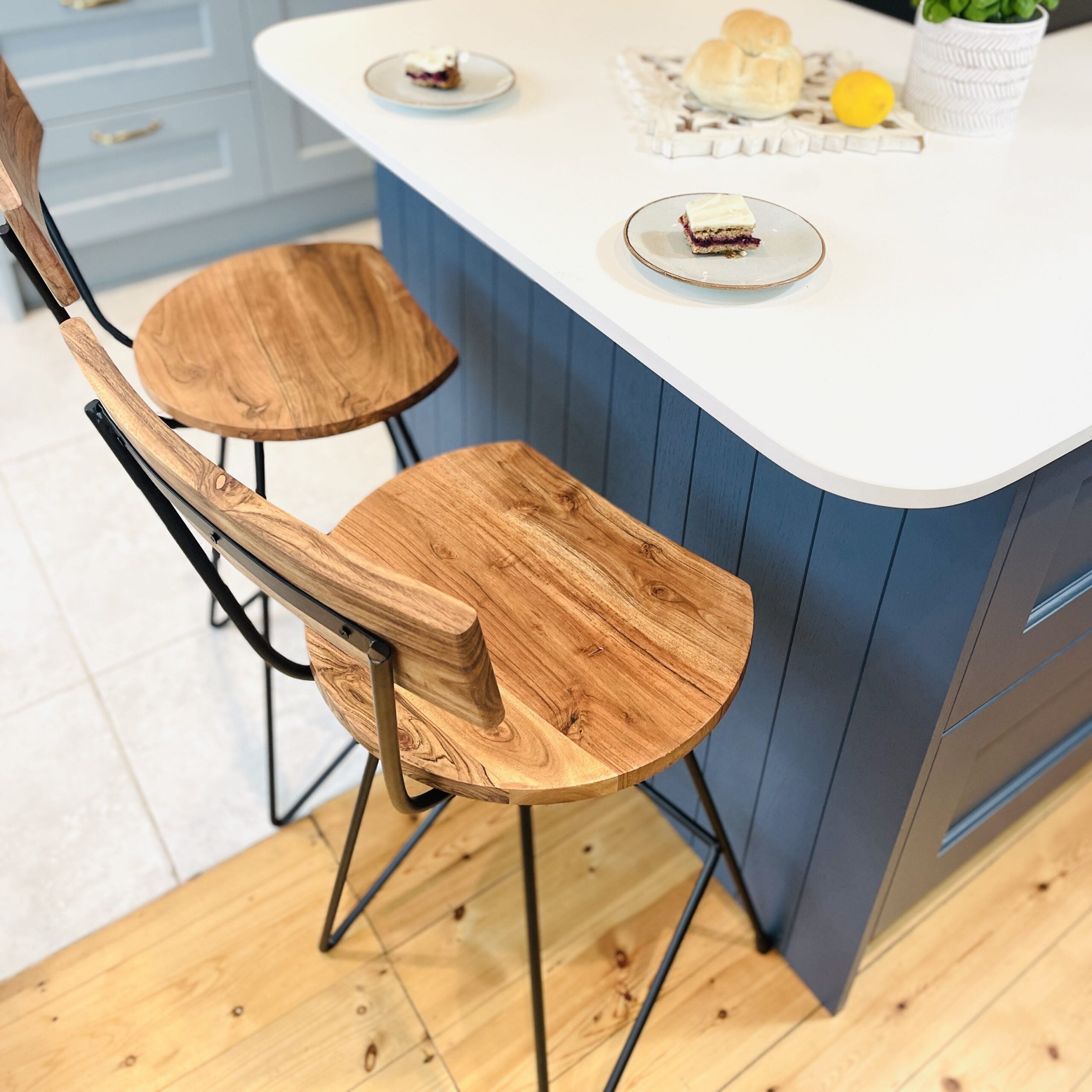 Top down view of industrial bar stools next to blue kitchen island