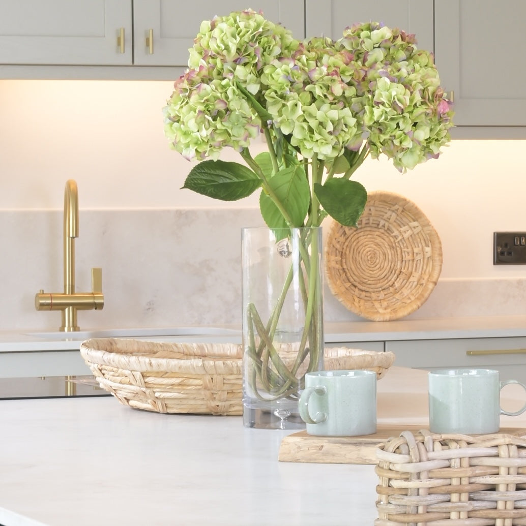 kitchen island with vase of flowers much and wicker bowl