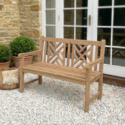 wooden garden bench on gravel patio with French doors