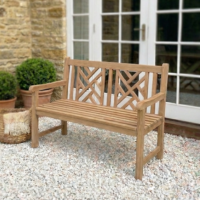 wooden garden bench on gravel patio with French doors