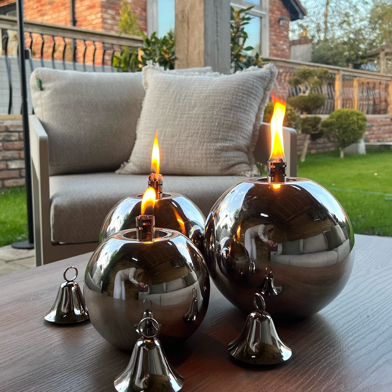 Garden oil lamps on garden patio table with chair