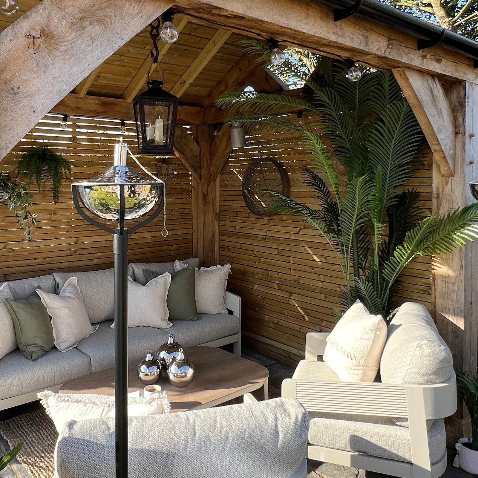 Garden seating area with plants and garden oil torch