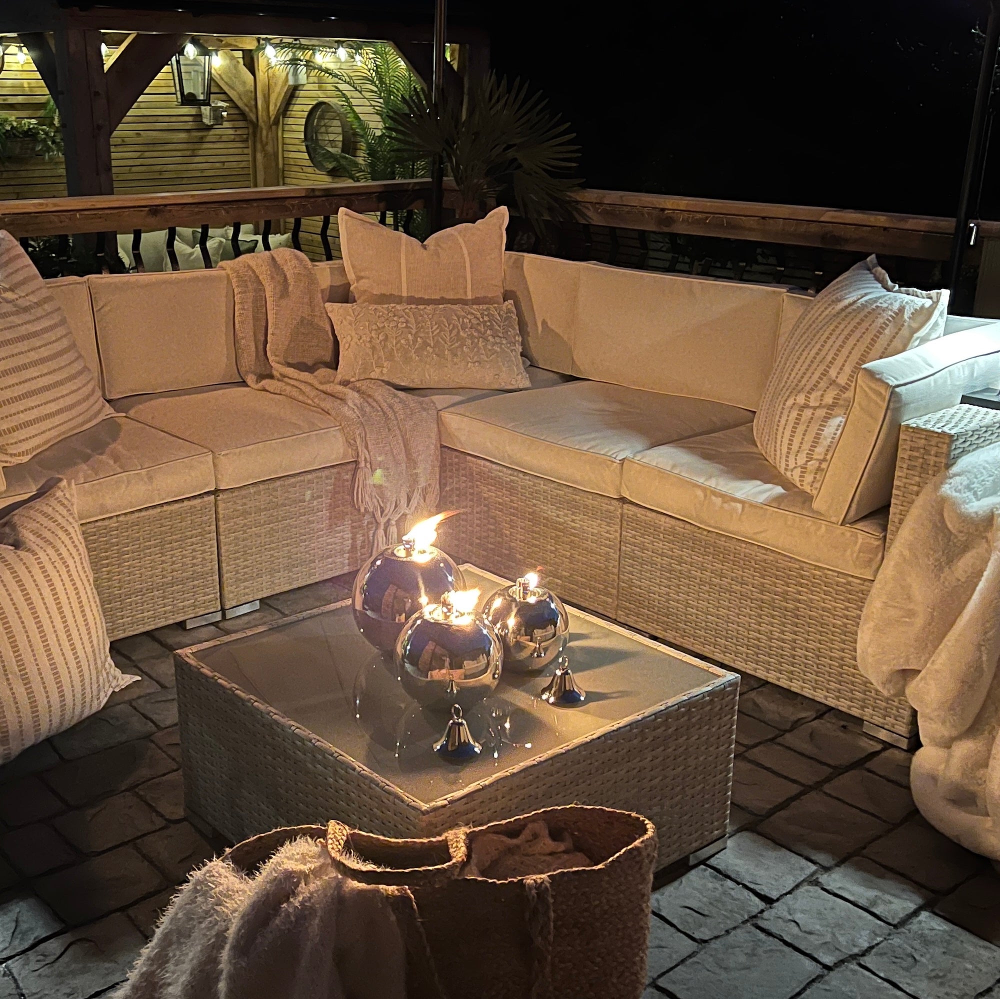 Patio area with large sofa and garden oil lamps