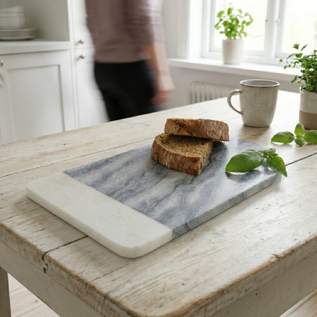grey marble slate serving board small with bread, cup, plant and person in background