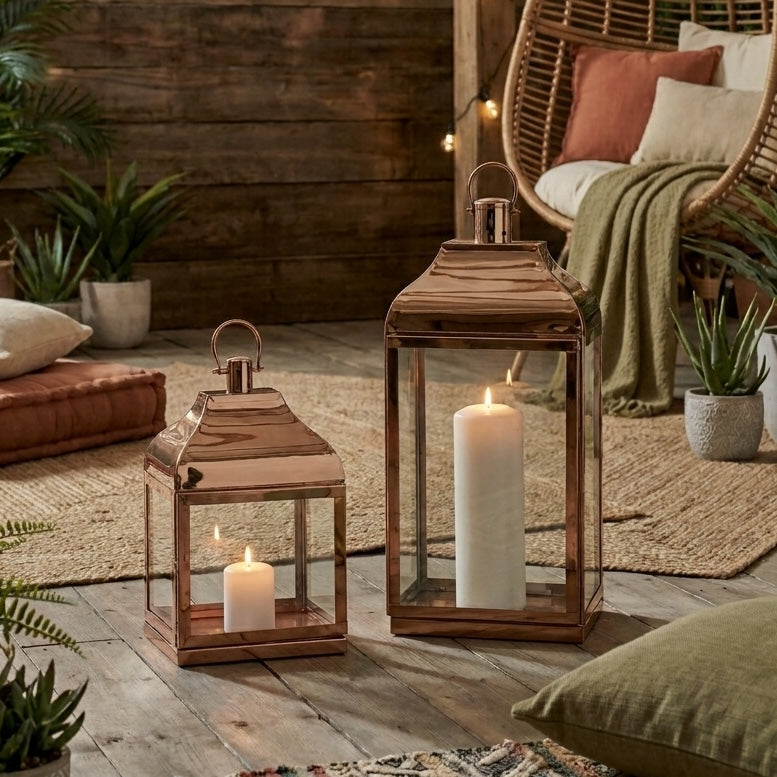 two rose gold lanterns surrounded by soft furnishings