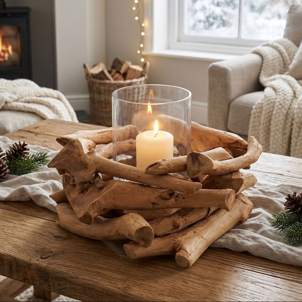 rustic driftwood candle holder with a glass votive, cosy winter setting with fire and candlelight