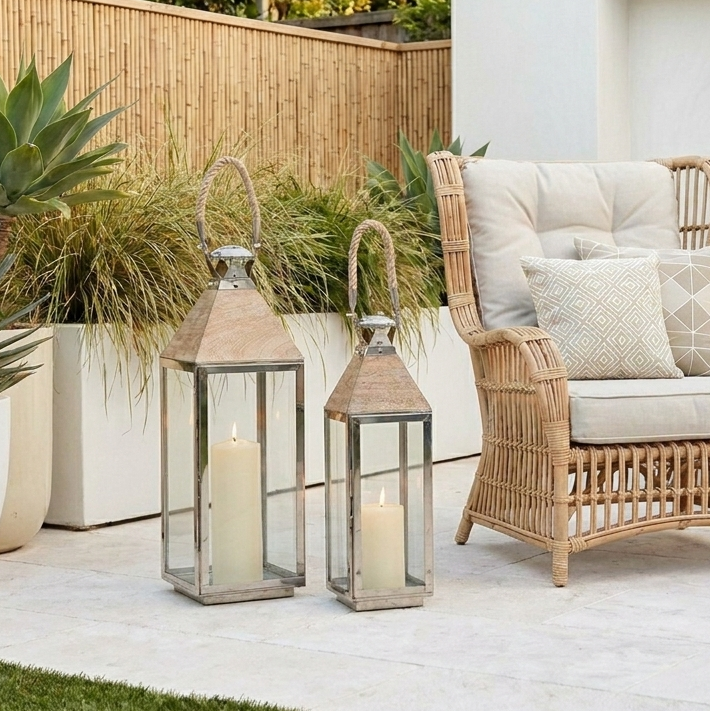 tall garden lanterns on patio with rattan garden chair
